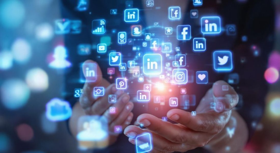 Person interacting with glowing social media icons.